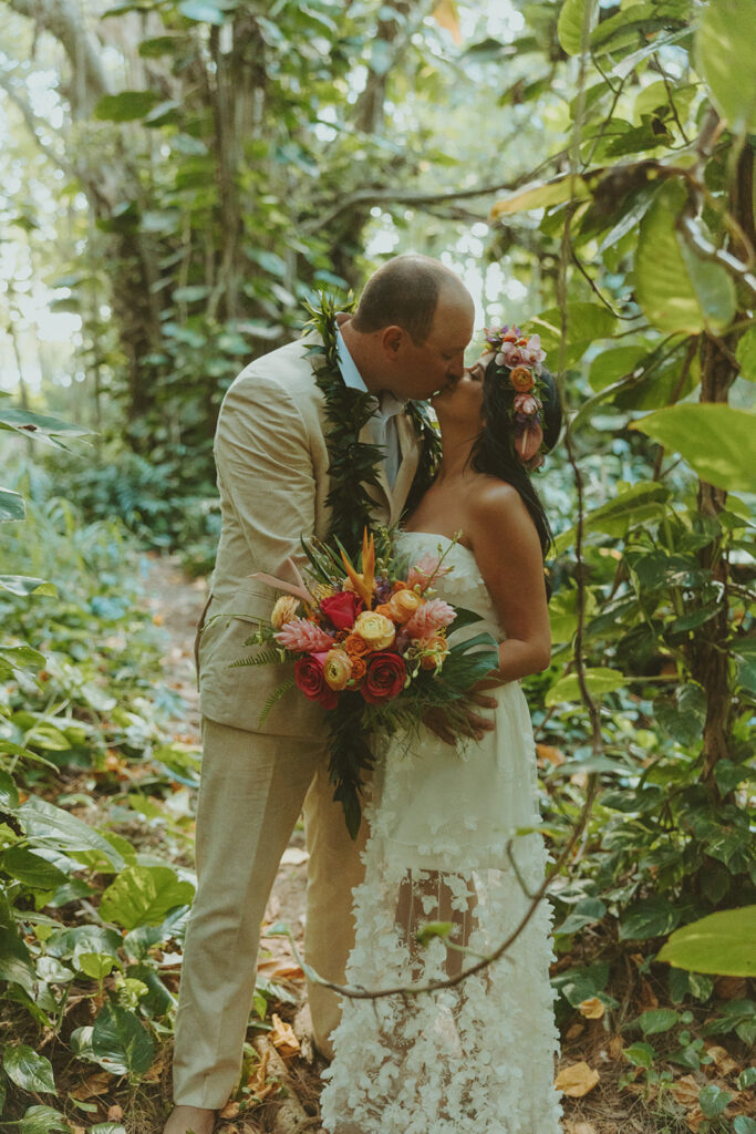 Newlyweds exploring a lush jungle location near Turtle Bay Resort after their ceremony.