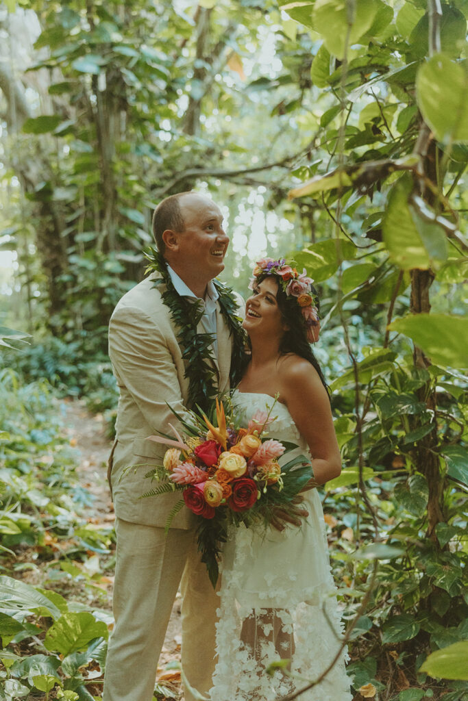 Newlyweds exploring a lush jungle location near Turtle Bay Resort after their ceremony.
