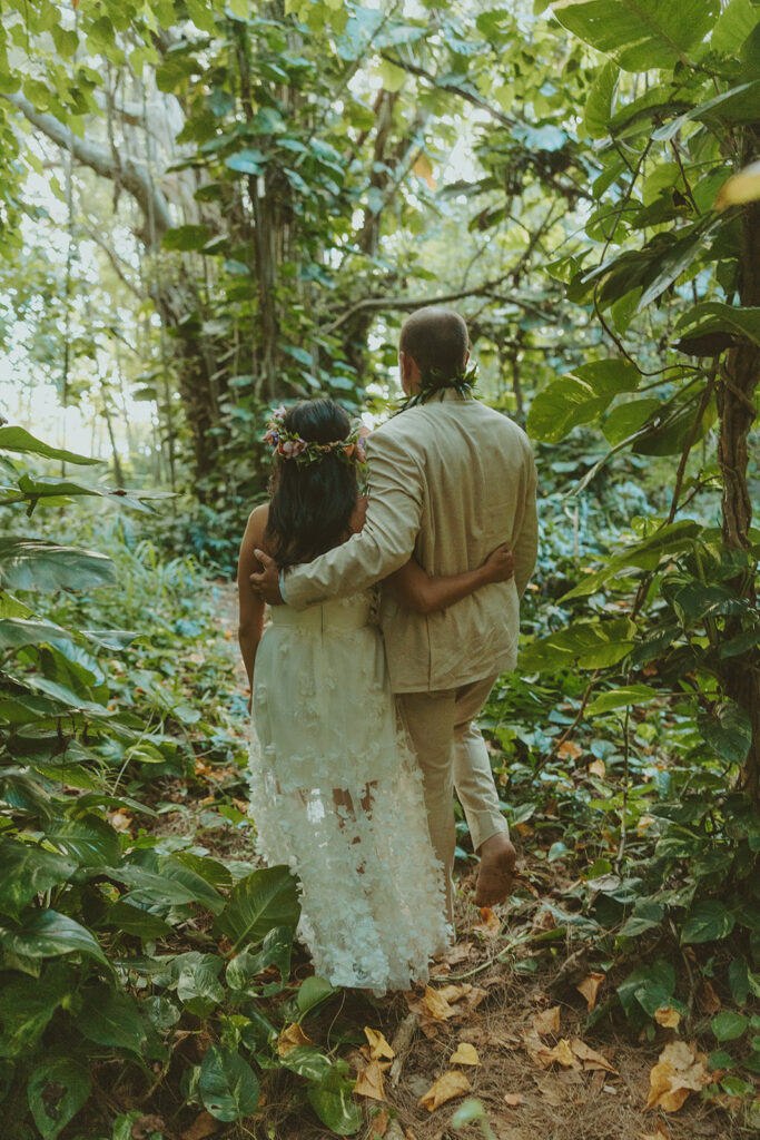 Romantic beach portraits of the couple surrounded by tropical scenery.
