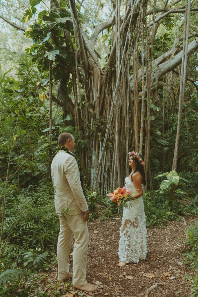 Newlyweds exploring a lush jungle location near Turtle Bay Resort after their ceremony.
