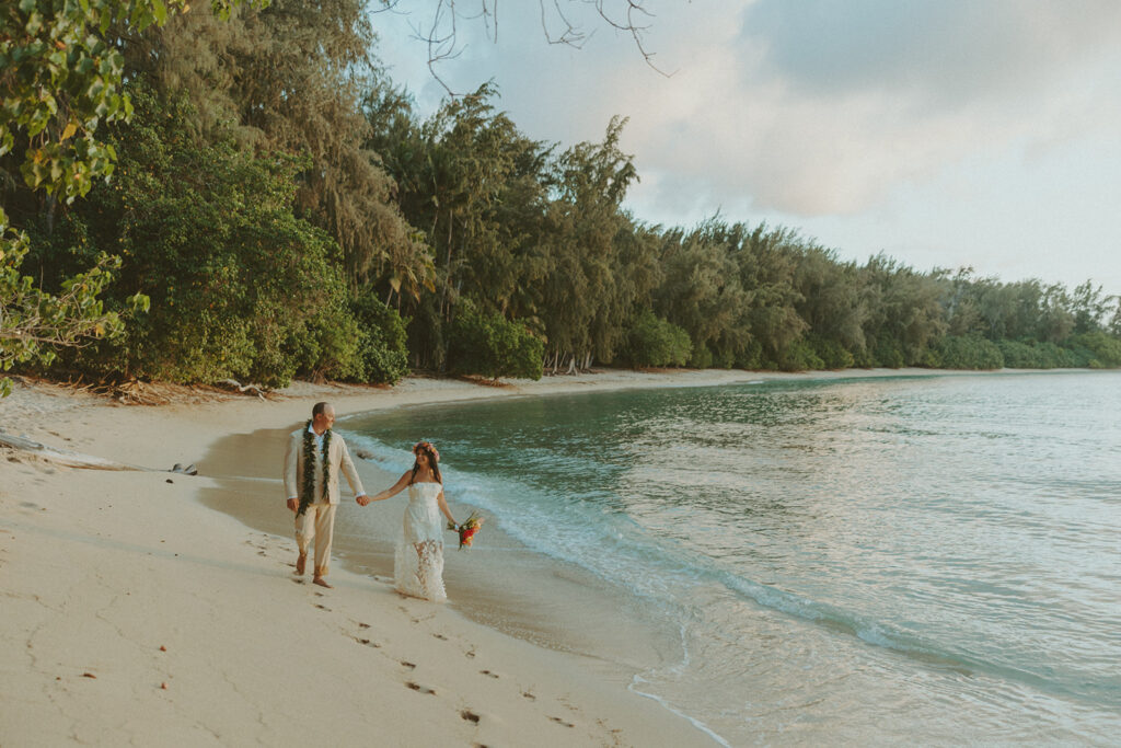 Sunset walk along the North Shore beach with golden light reflecting on the water.
