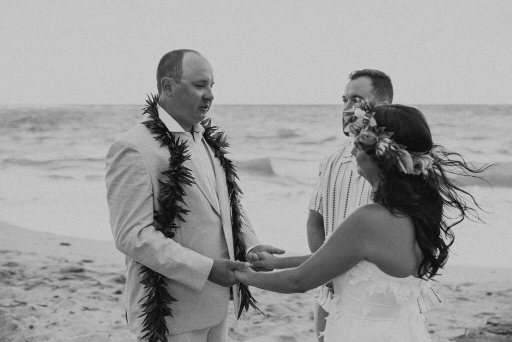 Bride and groom celebrating with their wedding party along the ocean shoreline.
North Shore Elopement in Oahu