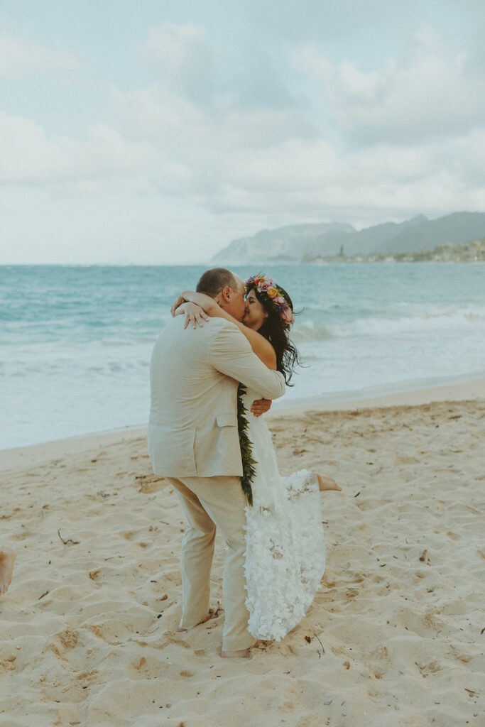 Bride and groom celebrating with their wedding party along the ocean shoreline.
North Shore Elopement in Oahu