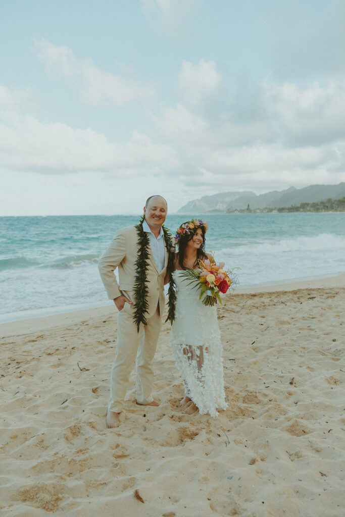 Bride and groom celebrating with their wedding party along the ocean shoreline.
North Shore Elopement in Oahu