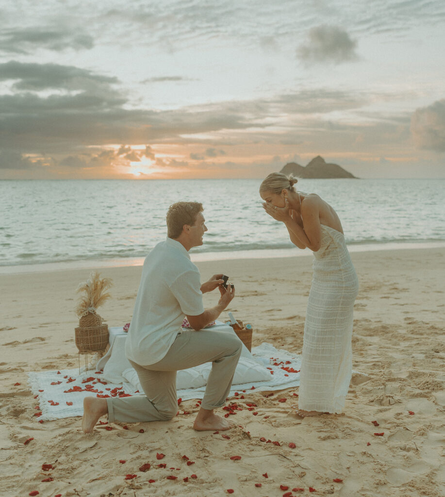 Romantic moment captured on the sand with ocean waves in the background | Lanikai Beach Proposal
