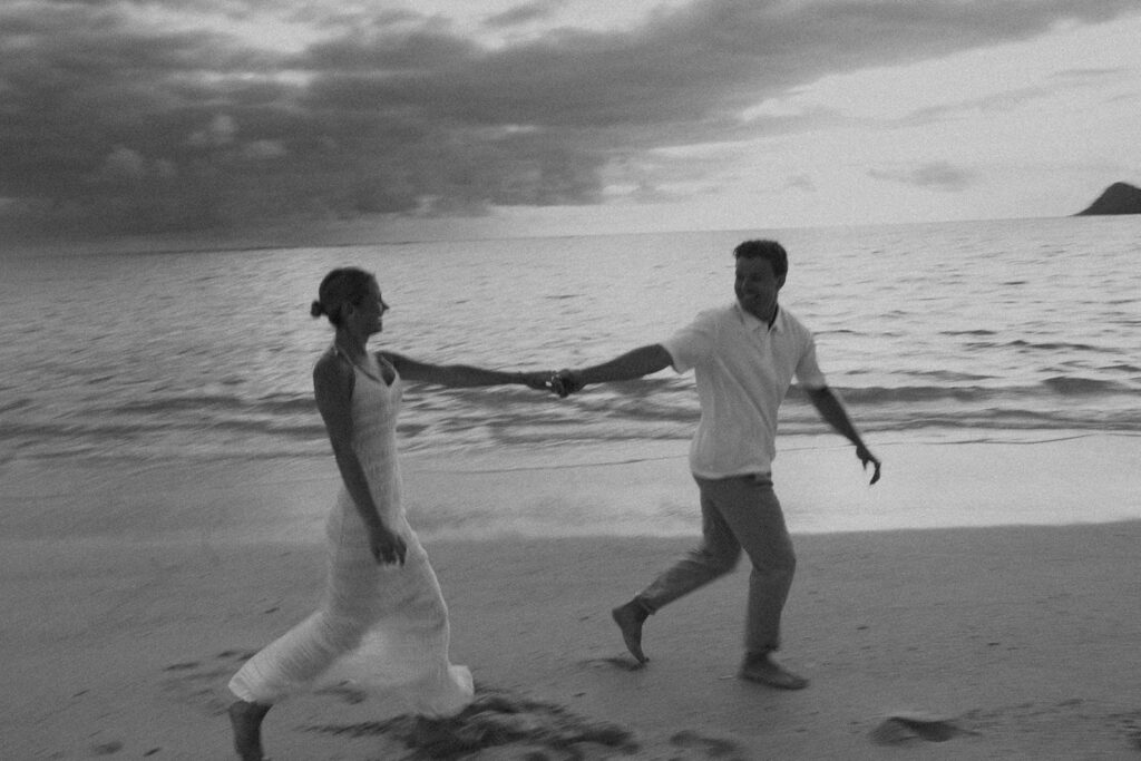 Couple embracing after a surprise proposal during golden hour by the water
 | Lanikai Beach Proposal