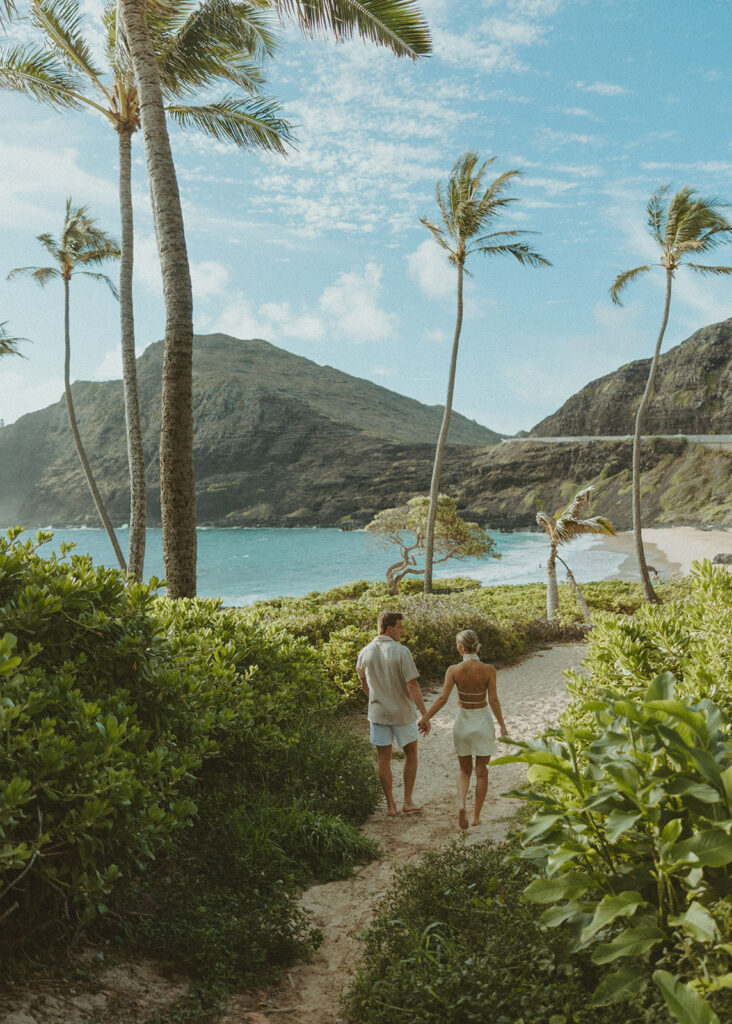 Romantic moment captured on the sand with ocean waves in the background
