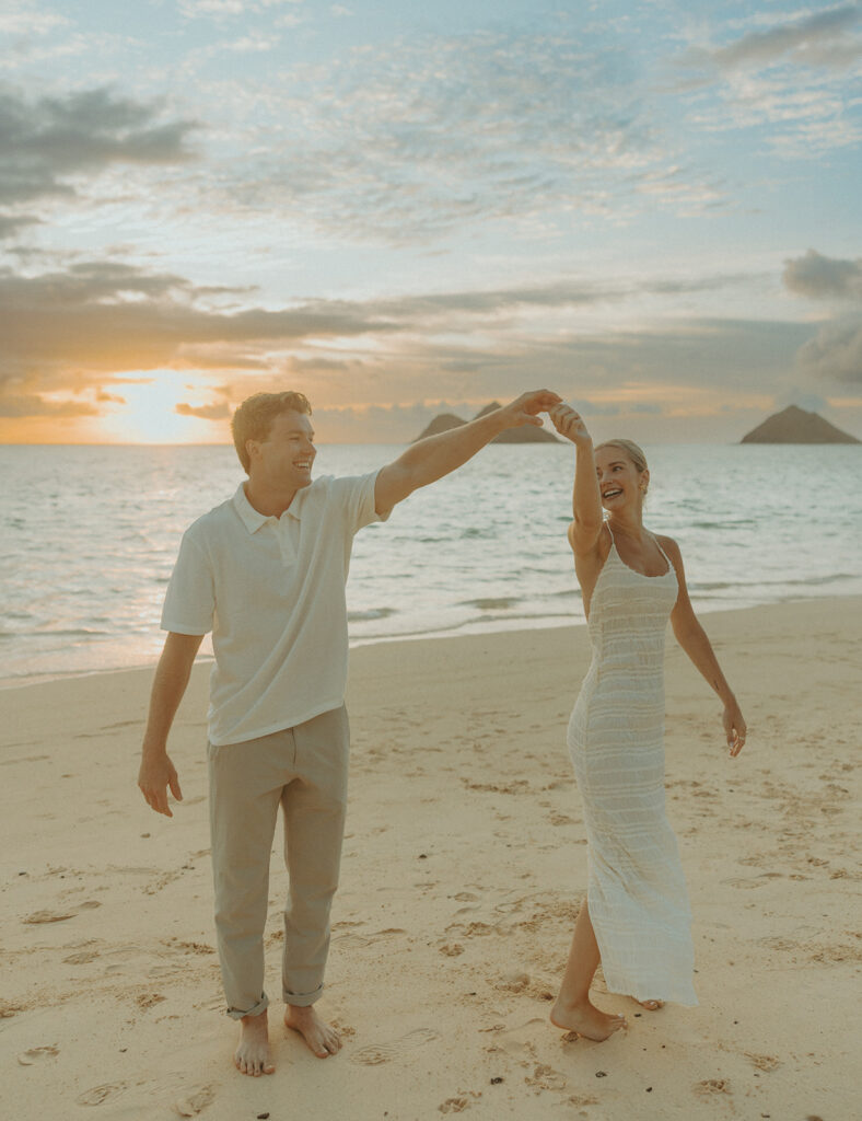 vRomantic moment captured on the sand with ocean waves in the background | Lanikai Beach Proposal
