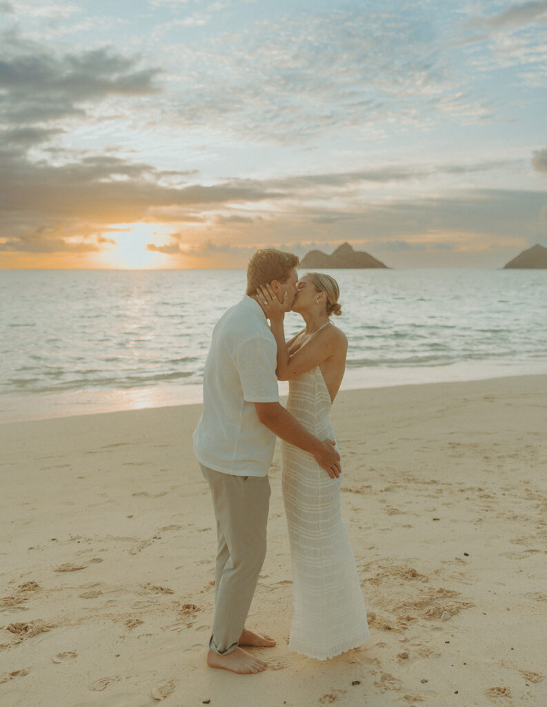 Romantic moment captured on the sand with ocean waves in the background | Lanikai Beach Proposal
