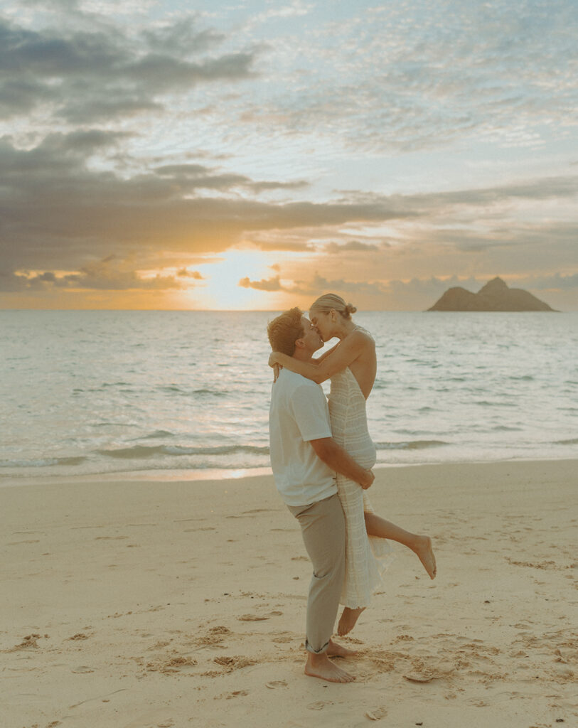 Couple embracing after a surprise proposal during golden hour by the water
 | Lanikai Beach Proposal