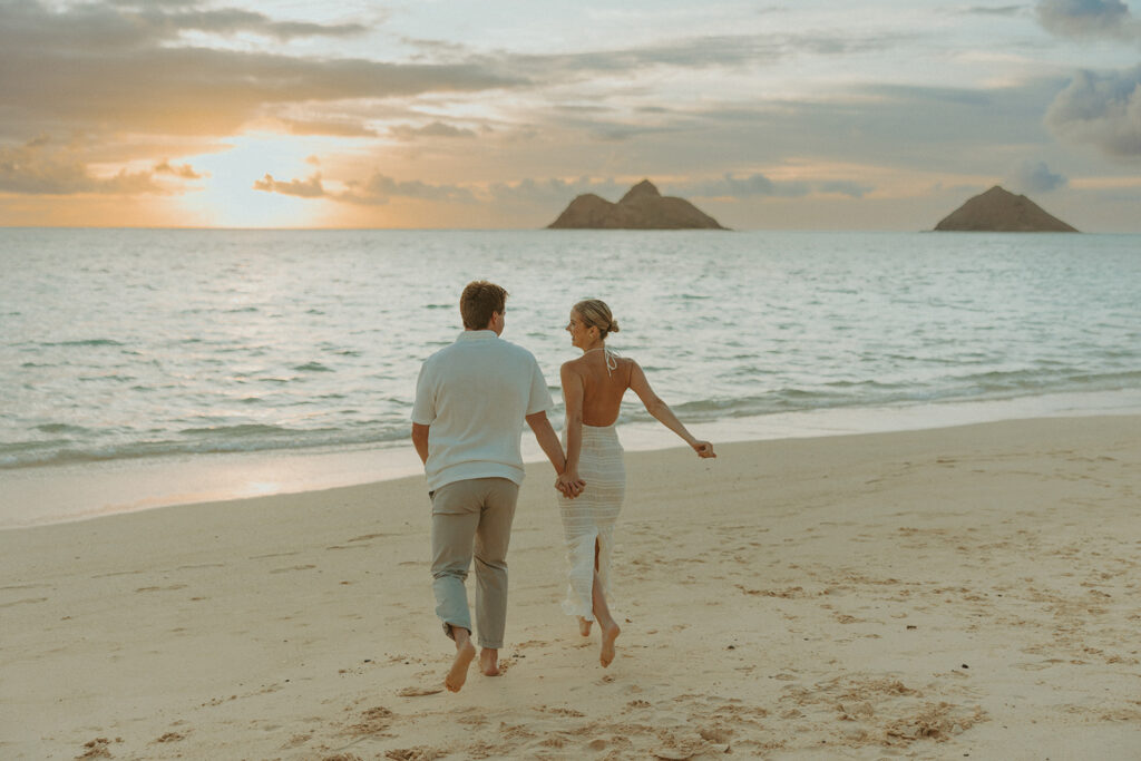 Romantic moment captured on the sand with ocean waves in the background
