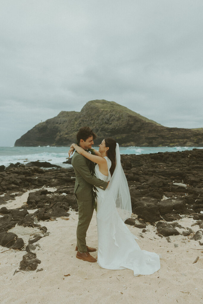 Couple standing together during their Makapuu Beach ceremony
