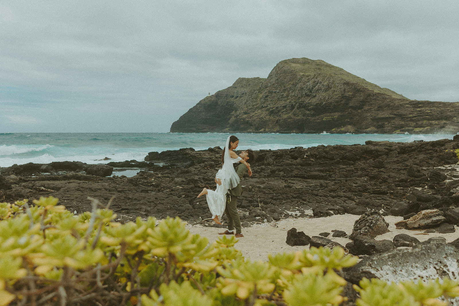 Couple standing together during their Makapuu Beach ceremony