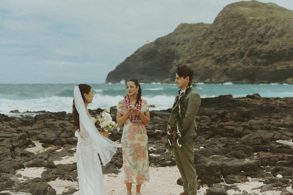 Couple standing together during their Makapuu Beach ceremony
