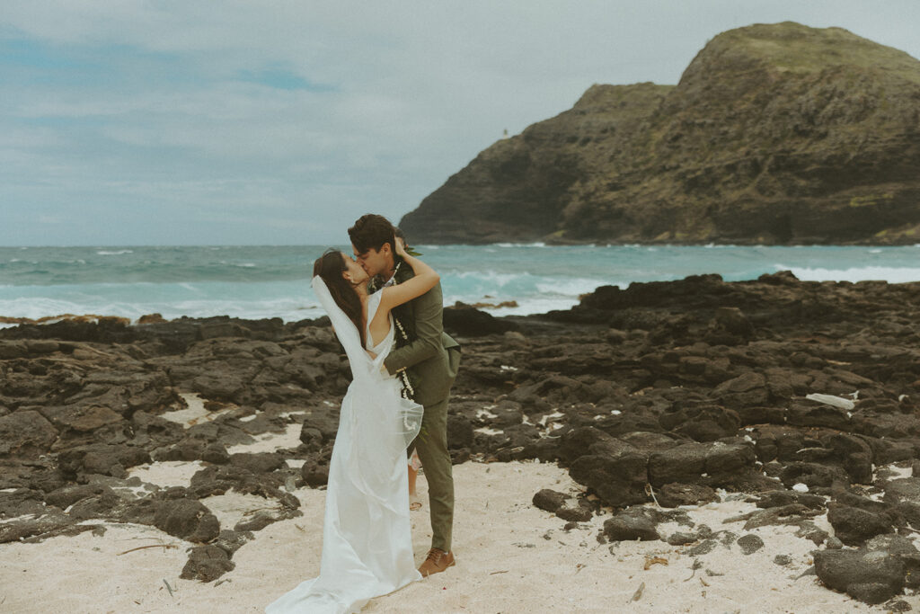Couple standing together during their Makapuu Beach ceremony
