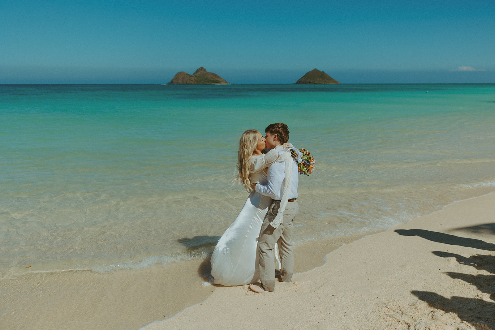 Couple standing on Lanikai Beach during their intimate elopement ceremony.