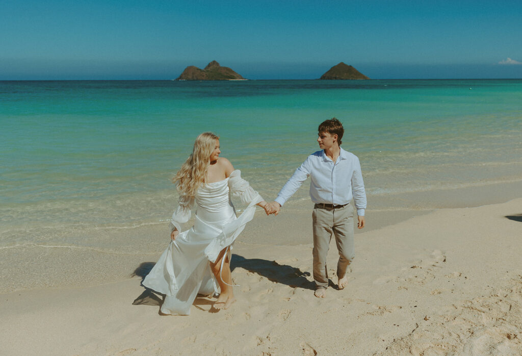Couple standing on Lanikai Beach during their intimate elopement ceremony.
