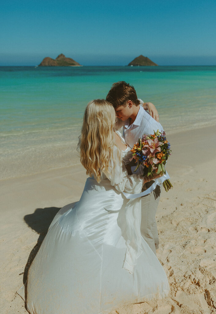 Couple standing on Lanikai Beach during their intimate elopement ceremony.
