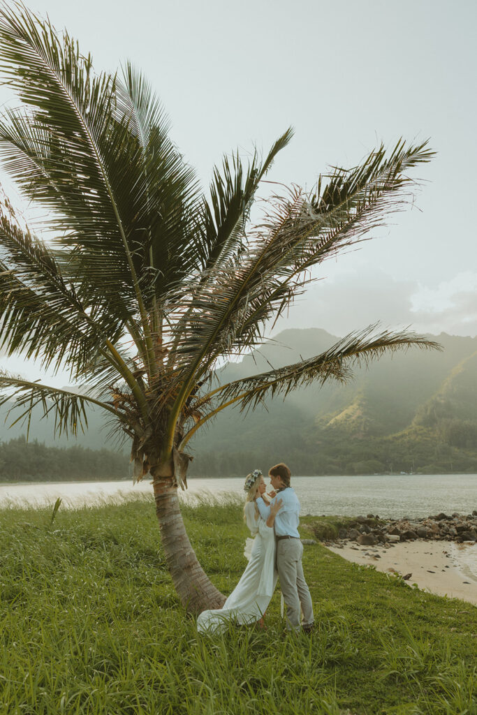 Couple hiking up the Crouching Lion trail surrounded by lush Oahu scenery.

