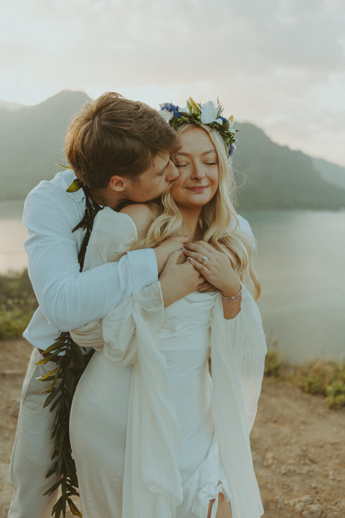 Elopement portraits overlooking the coastline from the top of Crouching Lion.
