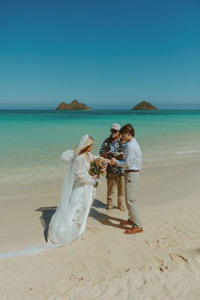 Couple standing on Lanikai Beach during their intimate elopement ceremony.