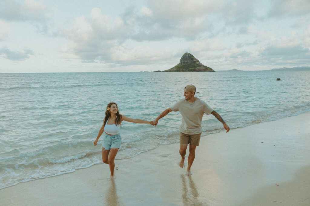 Couple enjoying a quiet moment by the ocean at Kualoa Regional Park in Hawaii
