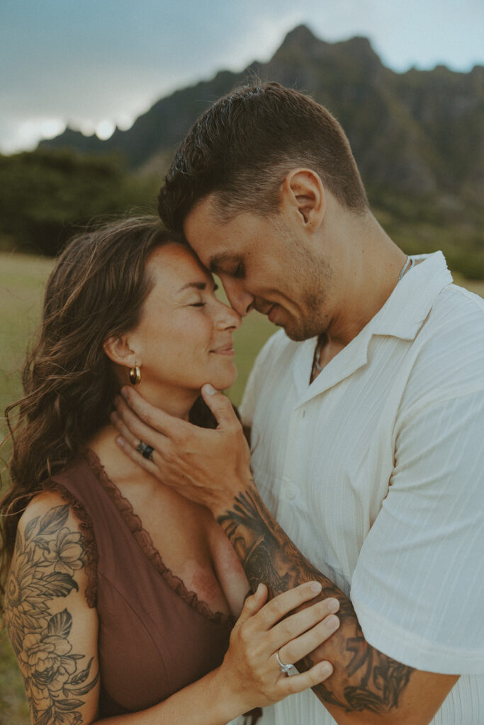 Husband and wife holding hands during a relaxed photo session at Kualoa Regional Park

