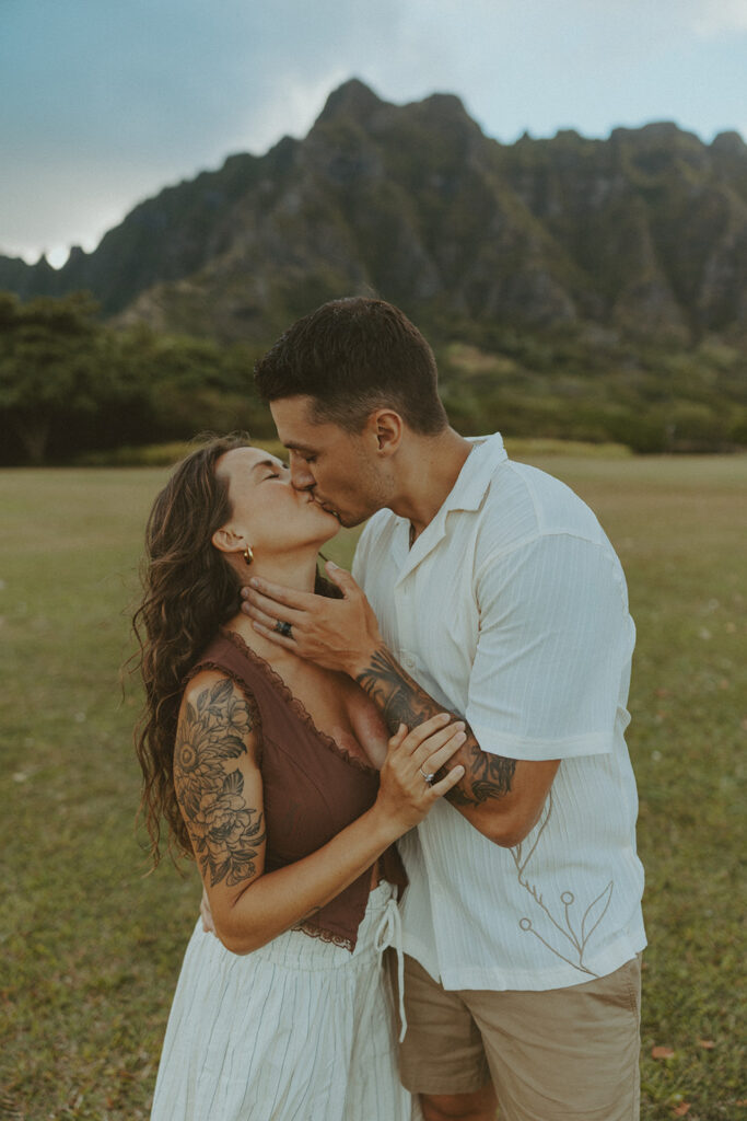 Anniversary couple standing in front of the mountains.