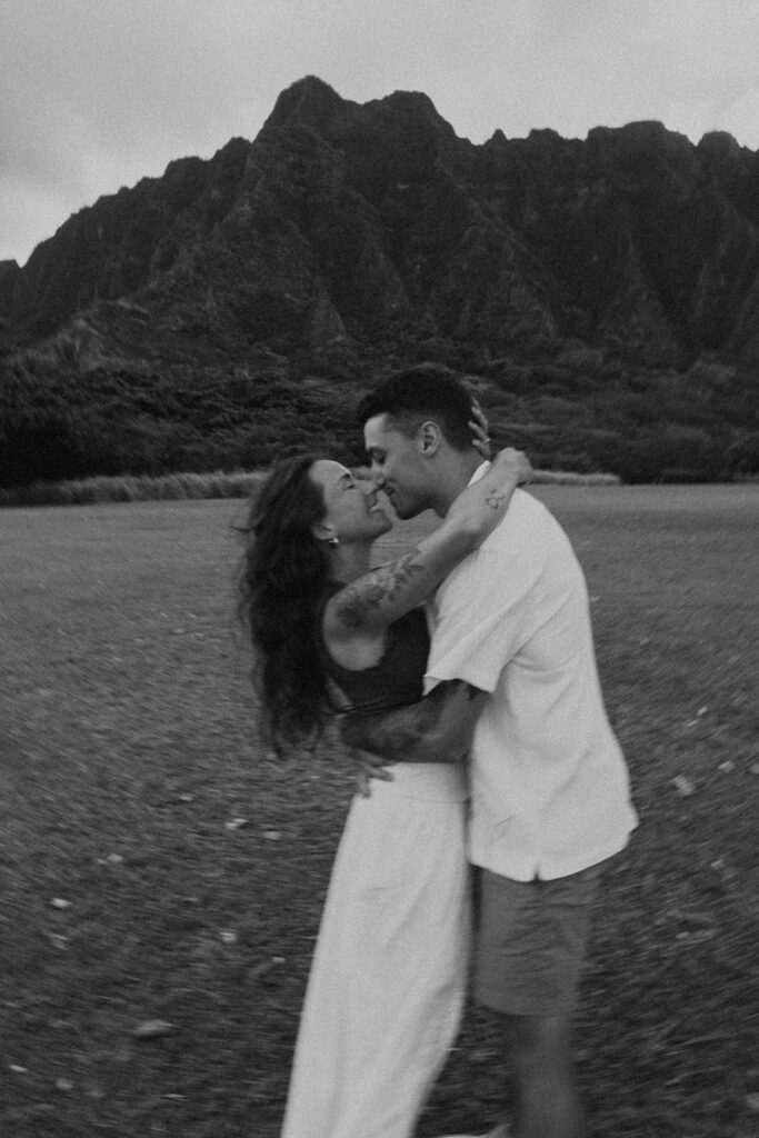 Husband and wife holding hands during a relaxed photo session at Kualoa Regional Park
