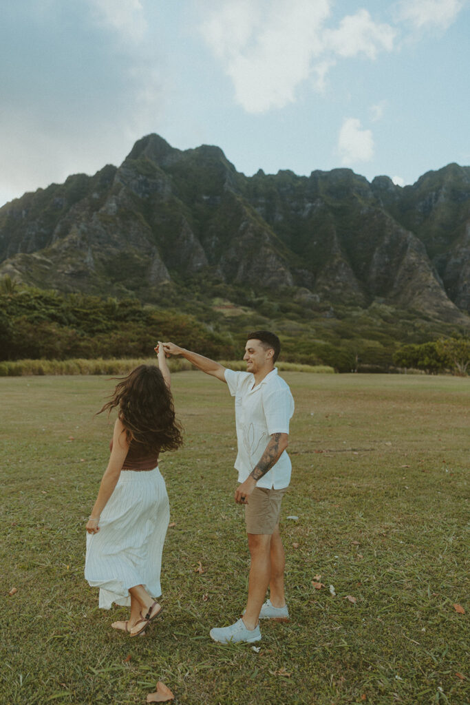 Husband and wife holding hands during a relaxed photo session at Kualoa Regional Park
