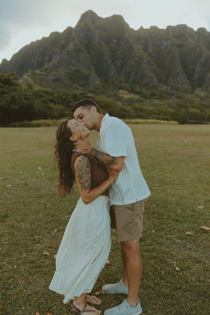 Anniversary couple standing in front of the mountains.
