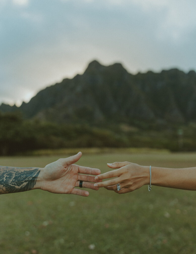 Anniversary couple standing in front of the mountains.
