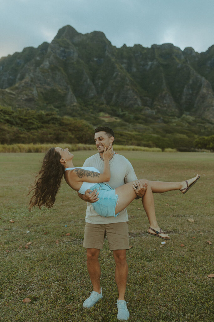 Anniversary couple standing in front of the mountains.
