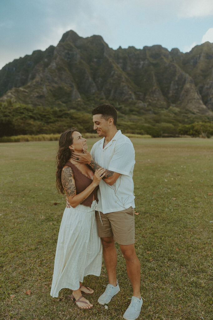 Husband and wife holding hands during a relaxed photo session at Kualoa Regional Park
