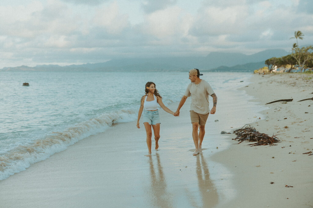 Anniversary couple standing in front of the mountains.
