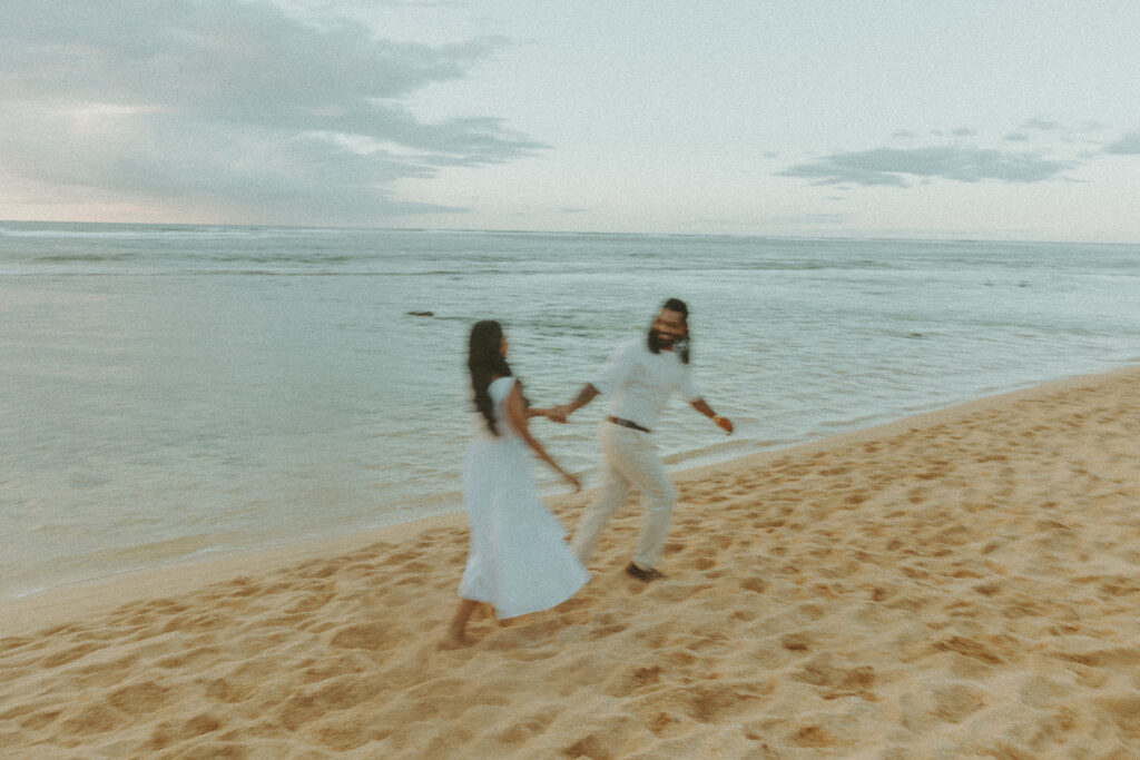 Newly engaged couple celebrating their proposal at 1 Hotel Hanalei Bay surrounded by tropical scenery