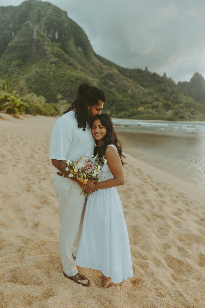Sunset engagement session at Tunnels Beach with mountains, ocean waves, and a relaxed Hawaii vibe