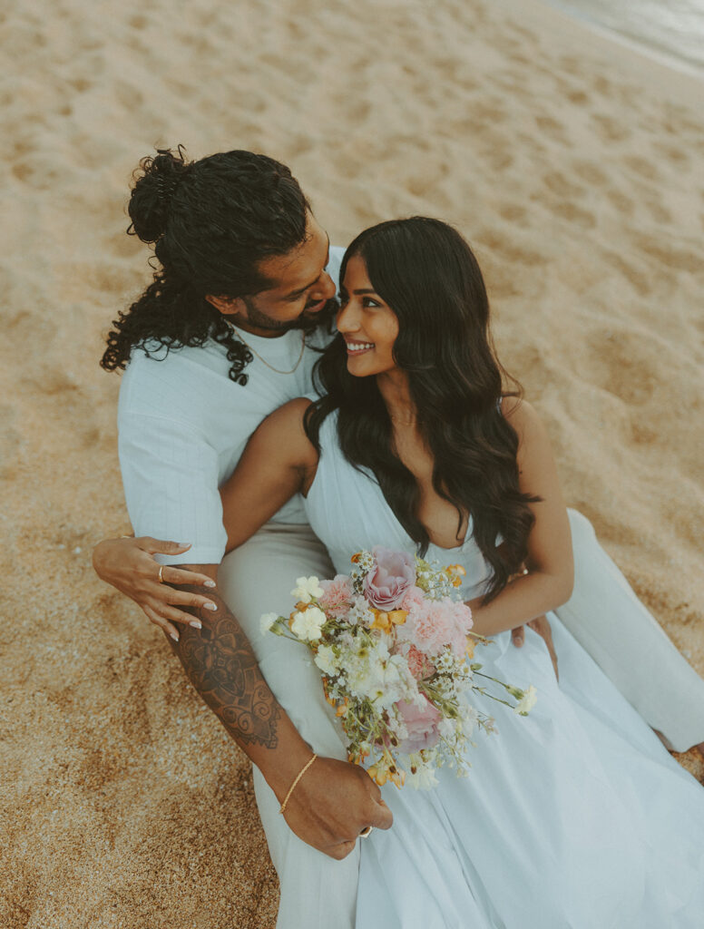 Couple walking along the shoreline at 1 Hotel Hanalei Bay on Kauai with ocean views and soft natural light
