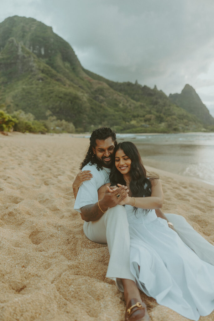 Sunset engagement session at Tunnels Beach with mountains, ocean waves, and a relaxed Hawaii vibe