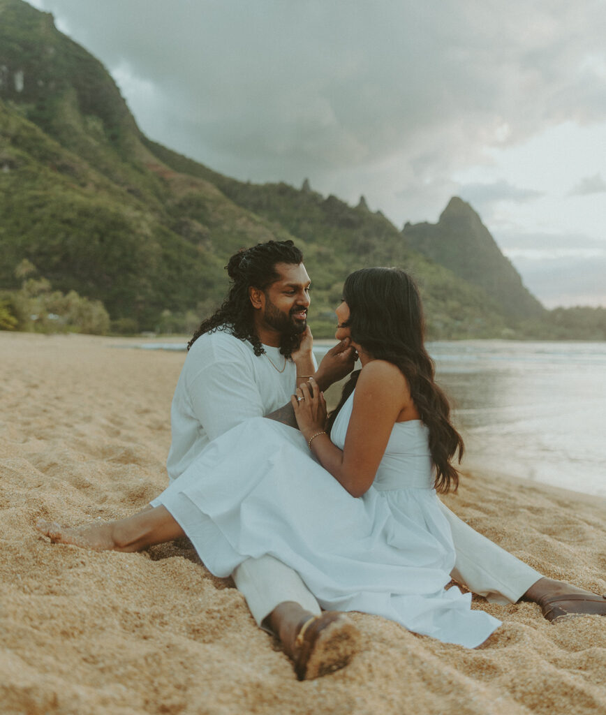 Sunset engagement session at Tunnels Beach with mountains, ocean waves, and a relaxed Hawaii vibe