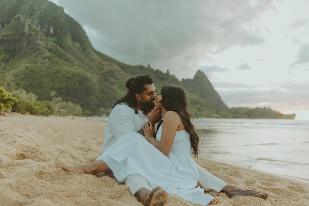 Sunset engagement session at Tunnels Beach with mountains, ocean waves, and a relaxed Hawaii vibe