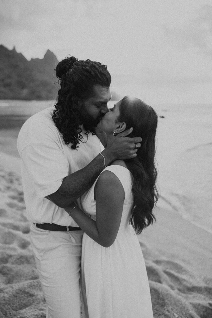 Sunset engagement session at Tunnels Beach with mountains, ocean waves, and a relaxed Hawaii vibe