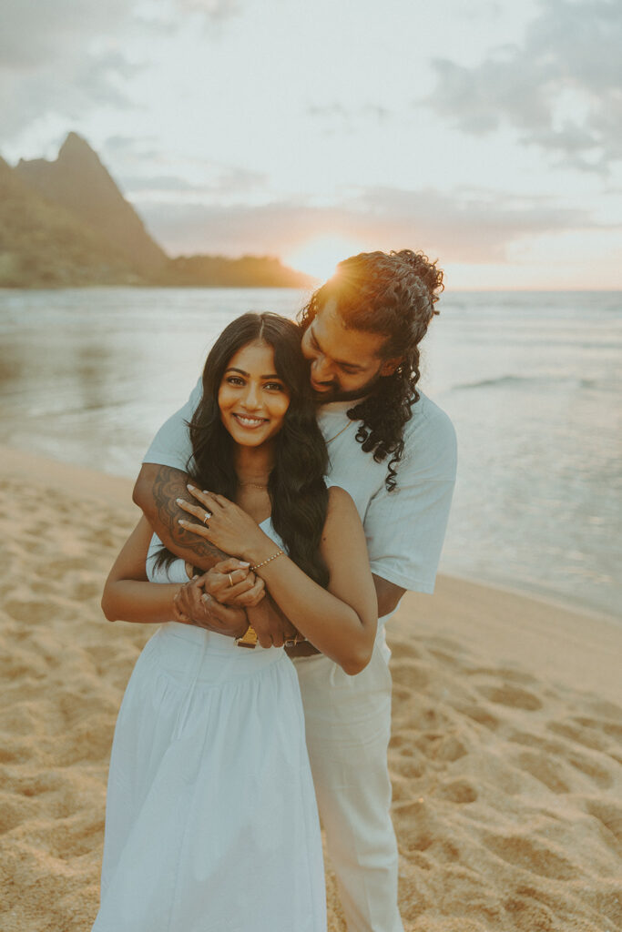 Sunset engagement session at Tunnels Beach with mountains, ocean waves, and a relaxed Hawaii vibe