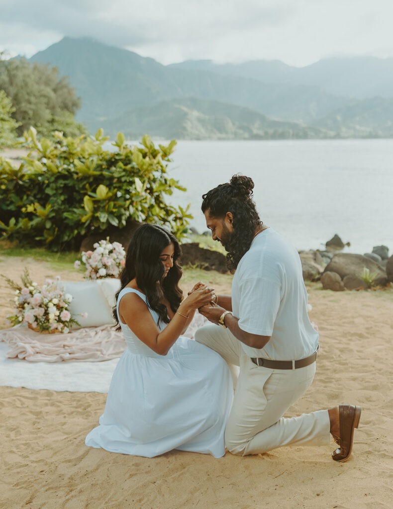Newly engaged couple celebrating their proposal at 1 Hotel Hanalei Bay surrounded by tropical scenery