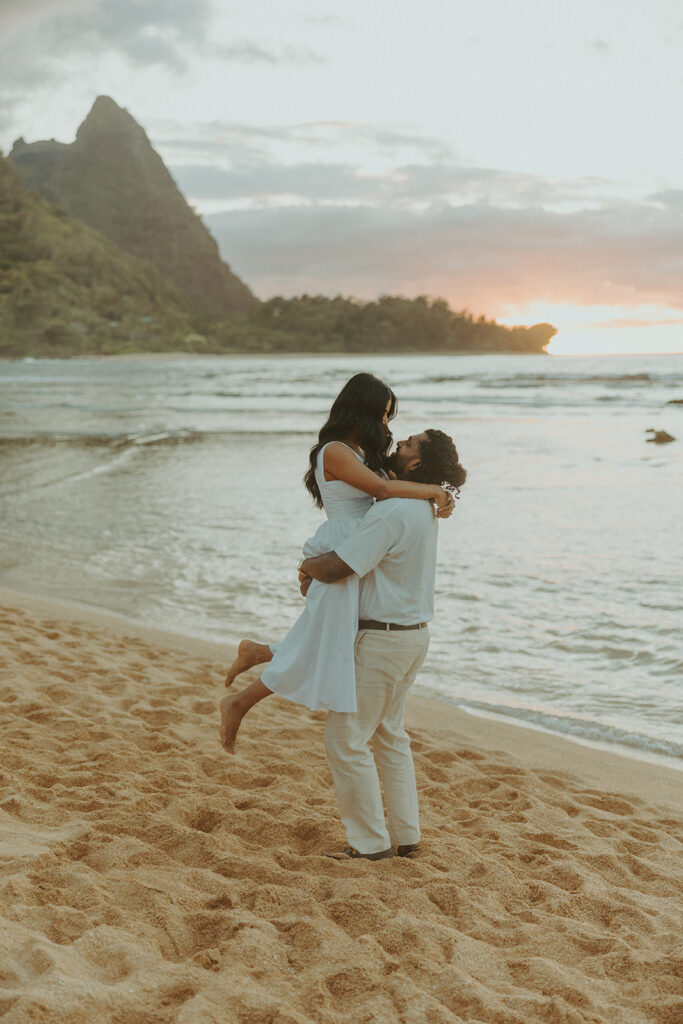 Sunset engagement session at Tunnels Beach with mountains, ocean waves, and a relaxed Hawaii vibe