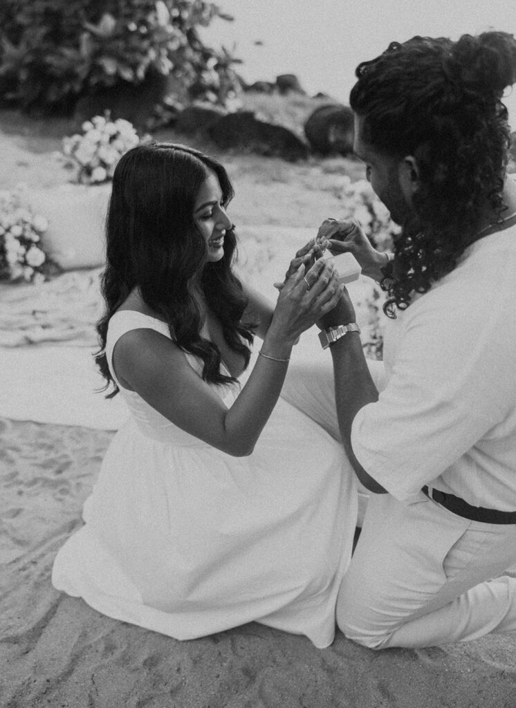 Newly engaged couple celebrating their proposal at 1 Hotel Hanalei Bay surrounded by tropical scenery