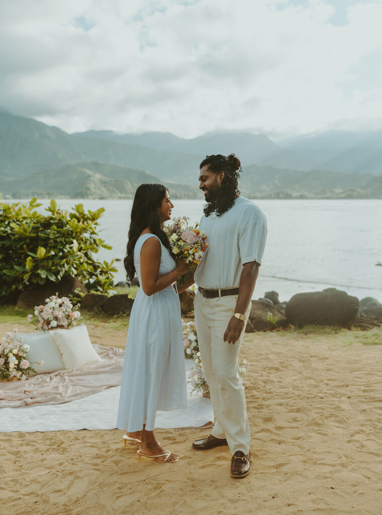 Newly engaged couple celebrating their proposal at 1 Hotel Hanalei Bay surrounded by tropical scenery
