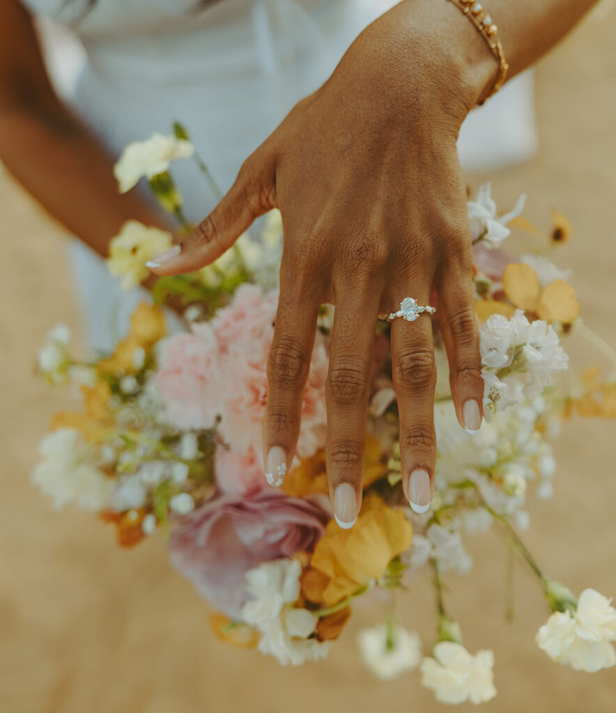 Romantic proposal setup with picnic details and flowers near the water at 1 Hotel Hanalei Bay