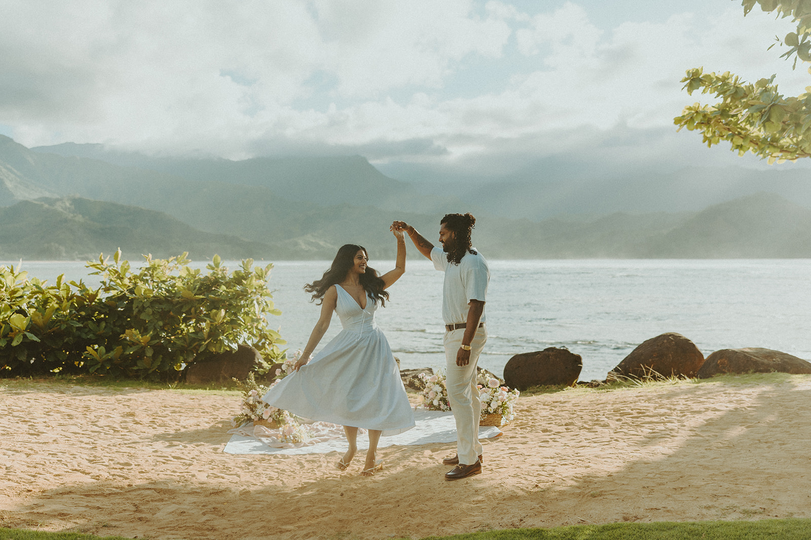 Couple walking along the shoreline at 1 Hotel Hanalei Bay on Kauai with ocean views and soft natural light