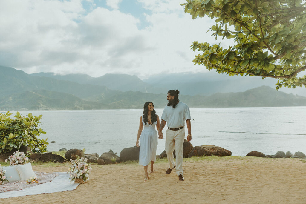 Newly engaged couple celebrating their proposal at 1 Hotel Hanalei Bay surrounded by tropical scenery